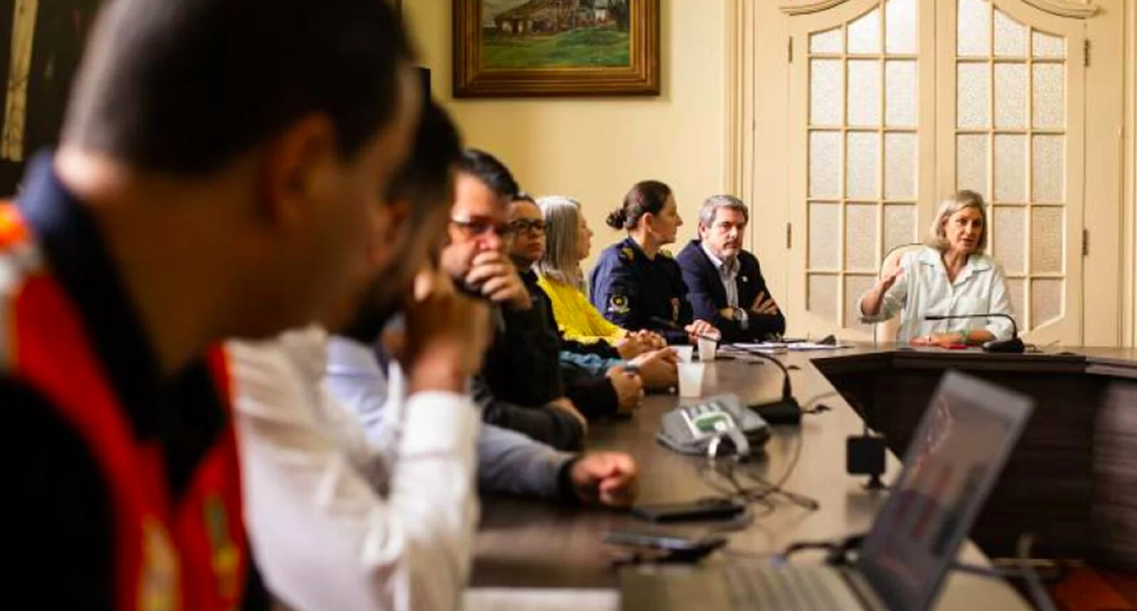 Individuals seated in an Integrated Management Office Meeting - Pacto Pelotas Pela Paz