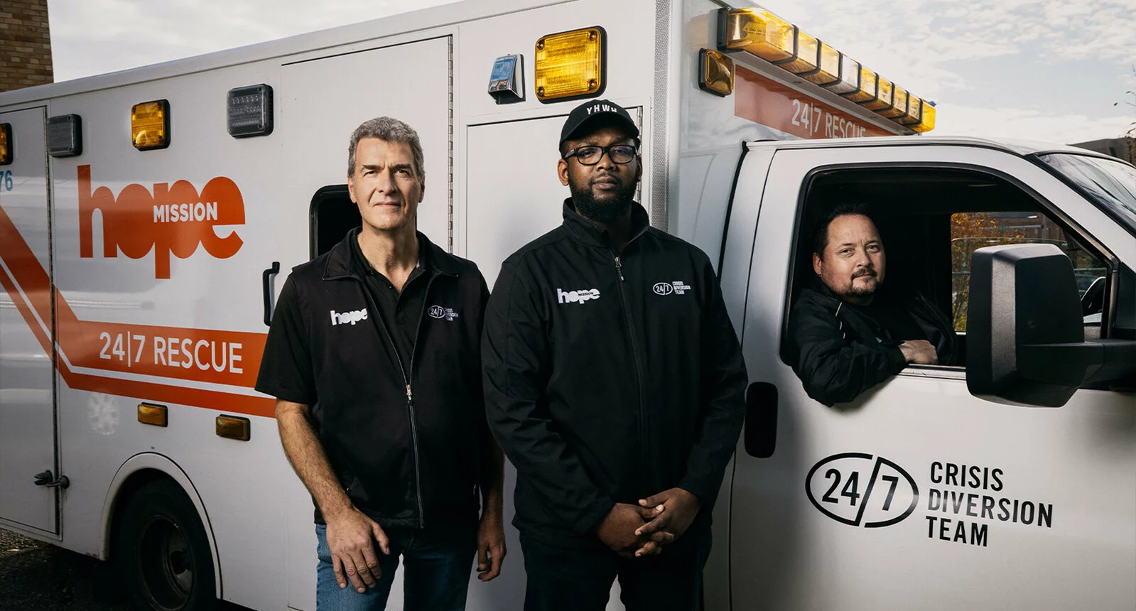 3 men next to a Hope Mission 24/7 Crisis Diversion rescue truck in Edmonton