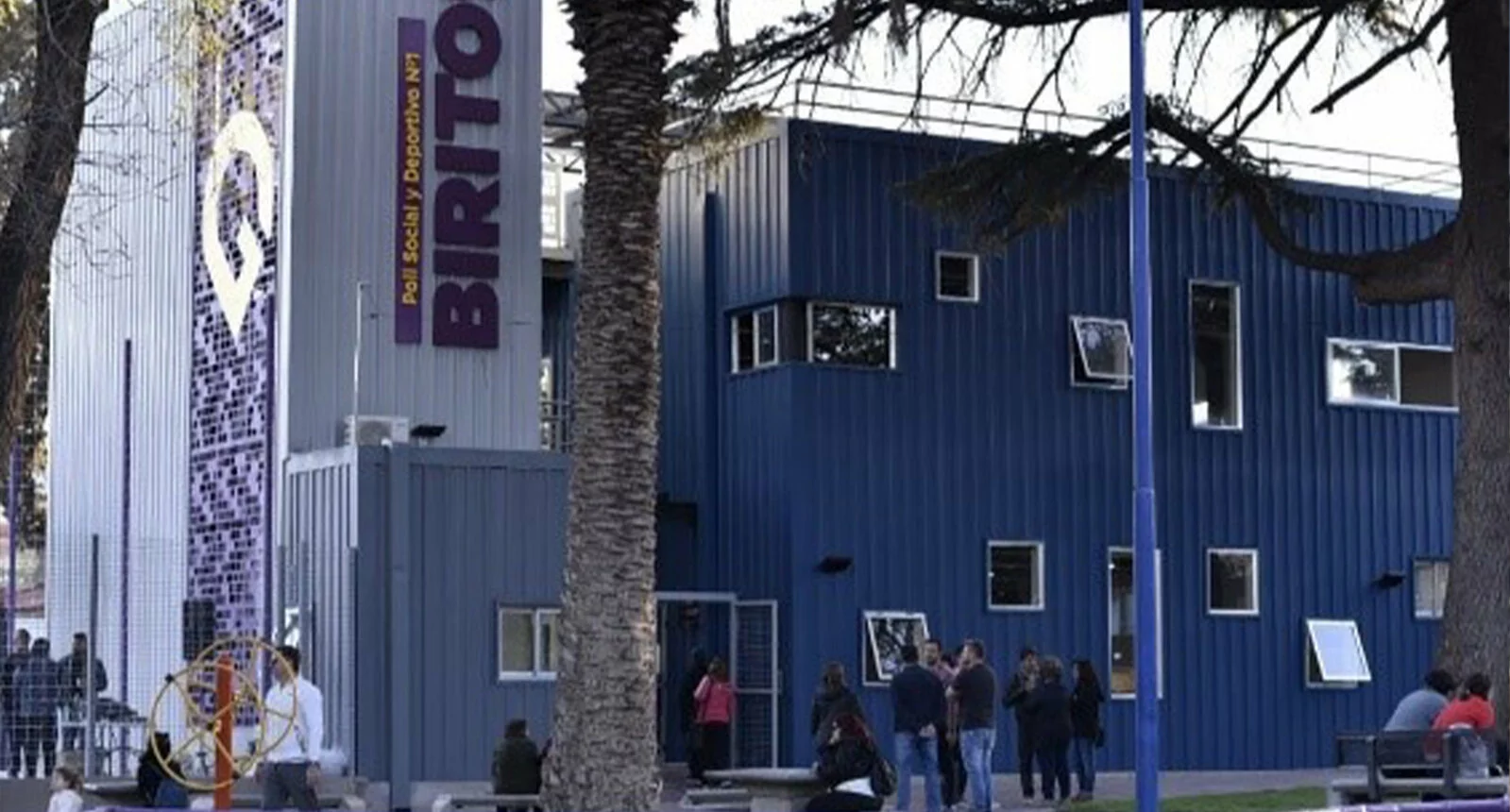 A few individuals talk outside of the Poli Biritos building