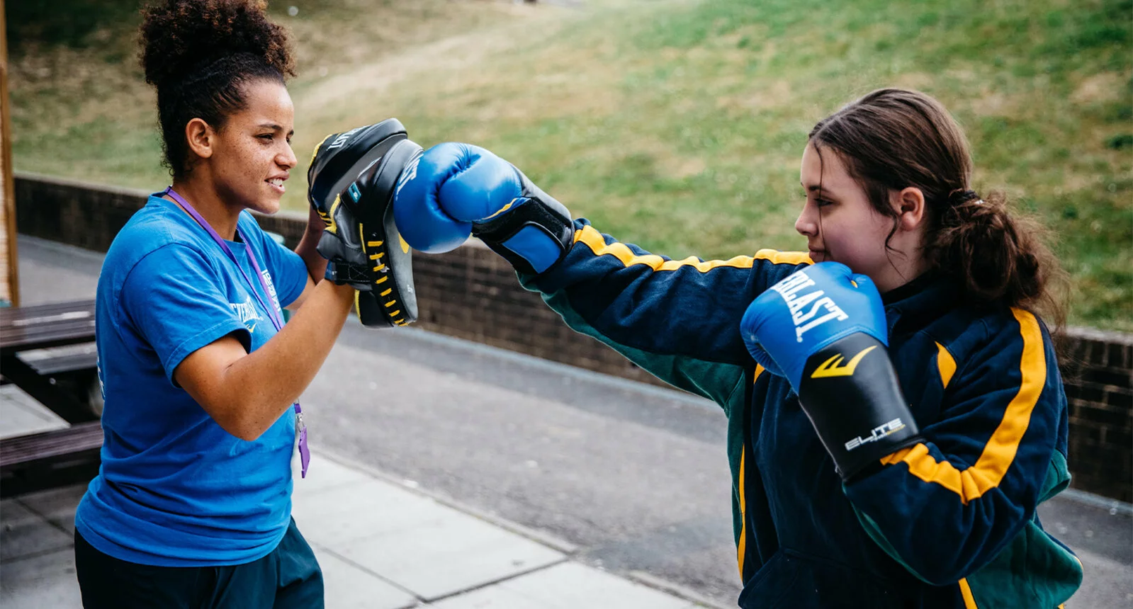 A boxing coach and student spar outside at Empire Fighting Chance in Bristol