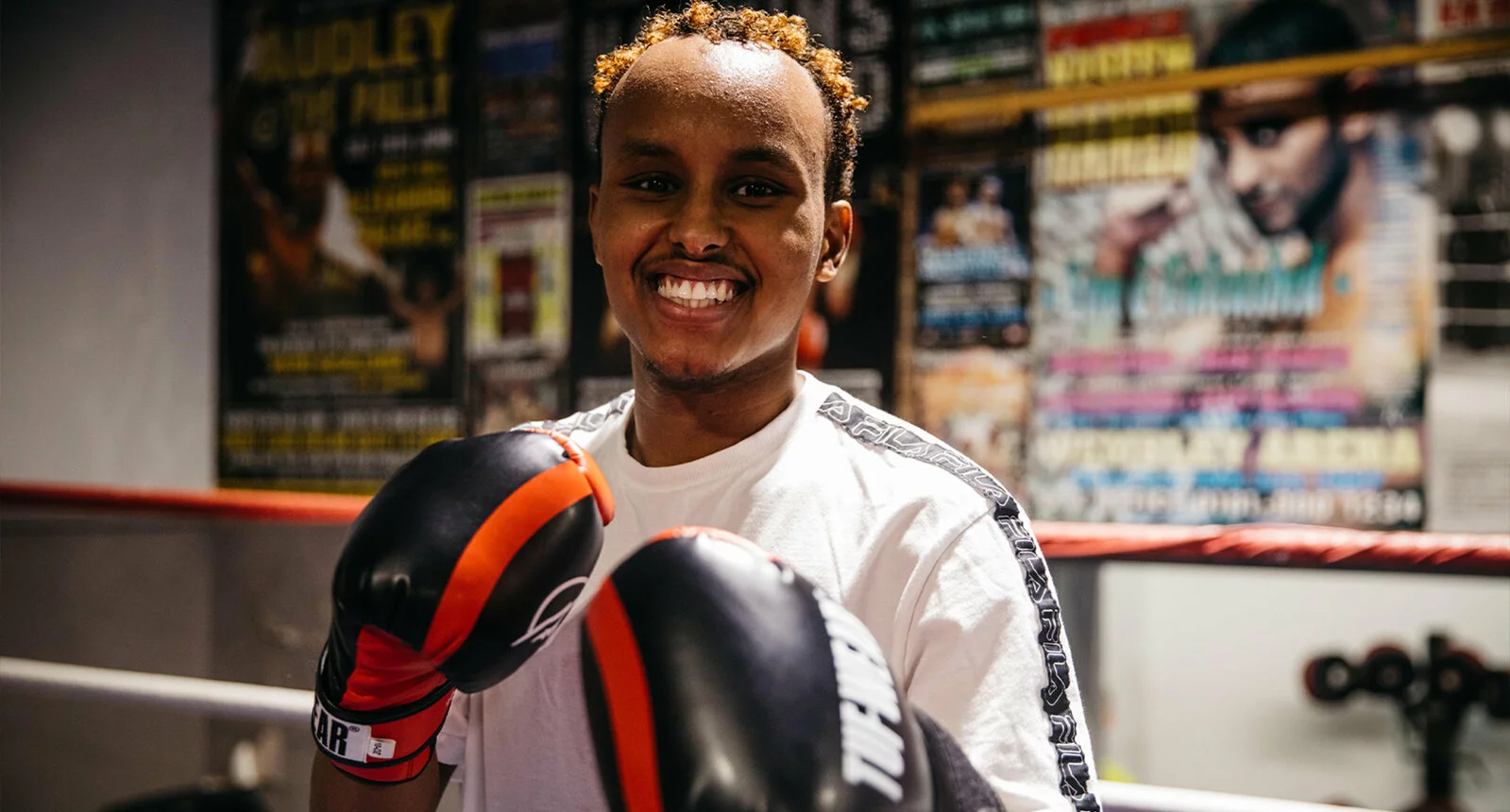 A boxer smiles inside the boxing ring at Empire Fighting Chance in Bristol