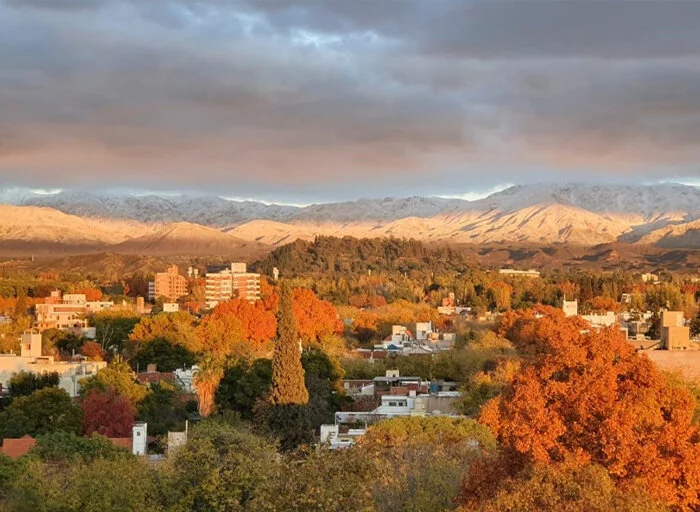 Aerial view of Godoy Cruz showing mountains, trees, and buildings
